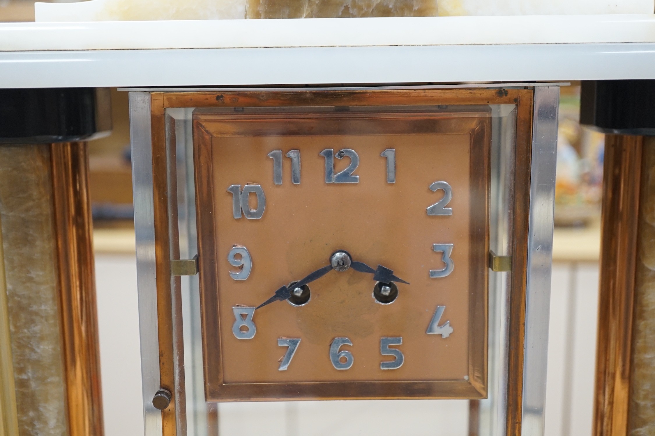 An Art Deco chrome, copper, brass and alabaster four glass mantel clock, 54cms wide